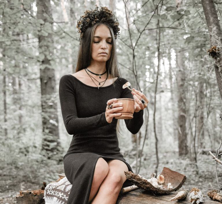 discovery of witches, witch in the woods making a potion with plants.