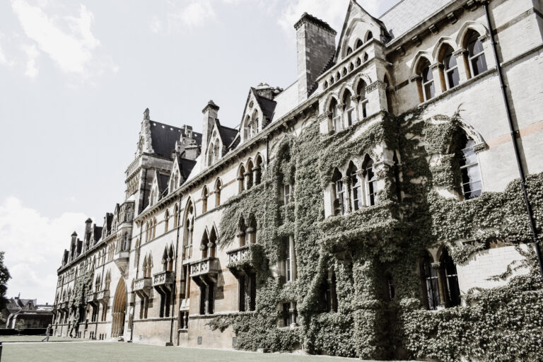lunar crest univiersity. photo of the exterior of a building covered in vines.
